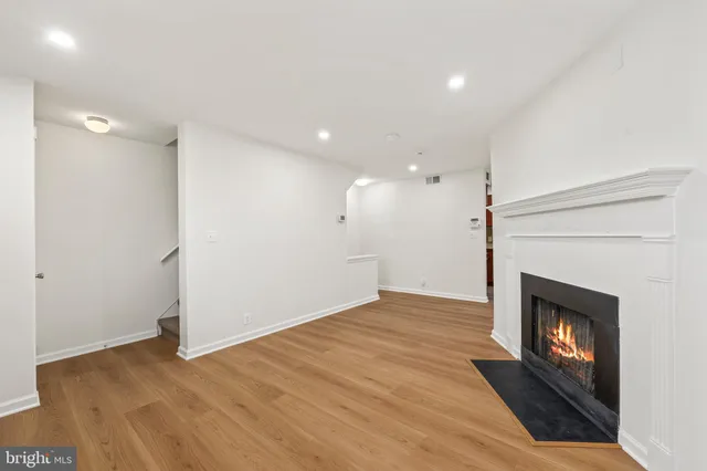 a view of an empty room and fire place