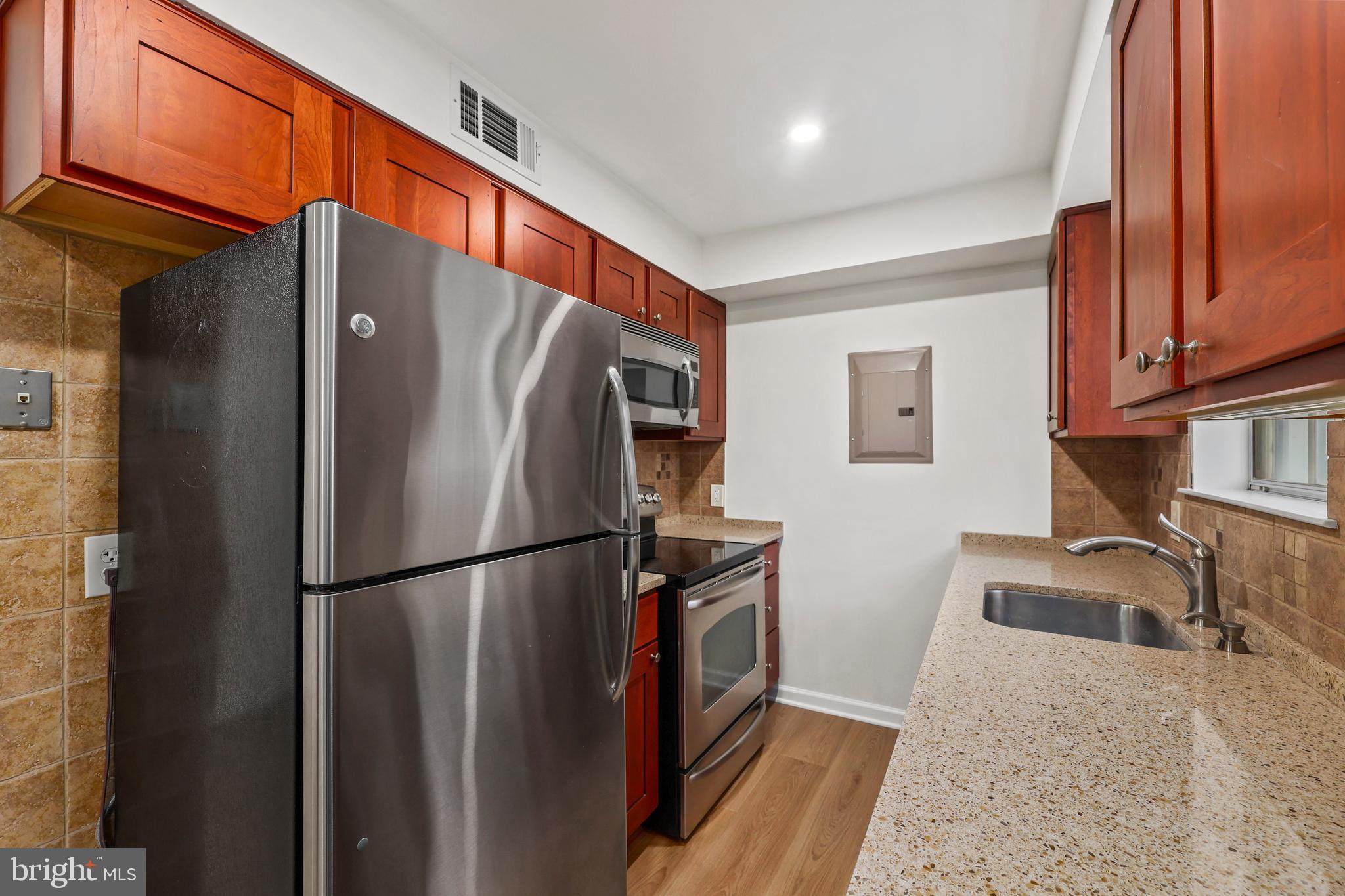 4619 28th Road South, Unit C Arlington, VA 22206 - Photo 2 of 31 a kitchen with stainless steel appliances granite countertop a refrigerator a sink and a stove