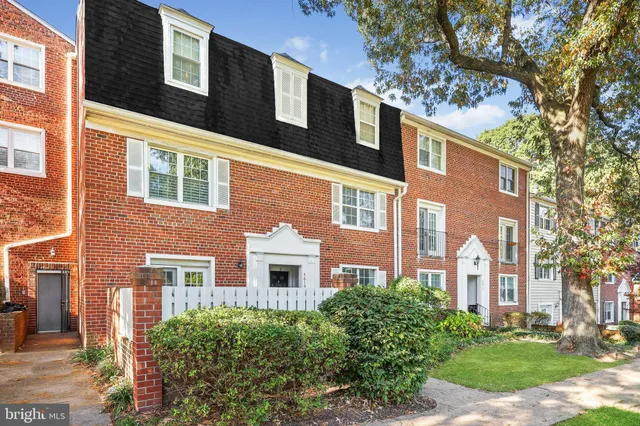 a front view of a building with a yard