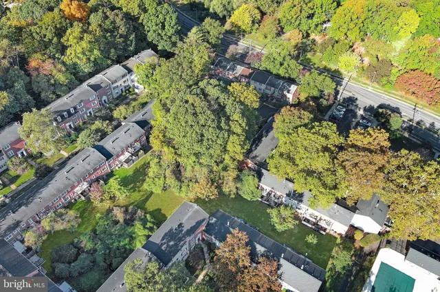 a yard with a multi story house