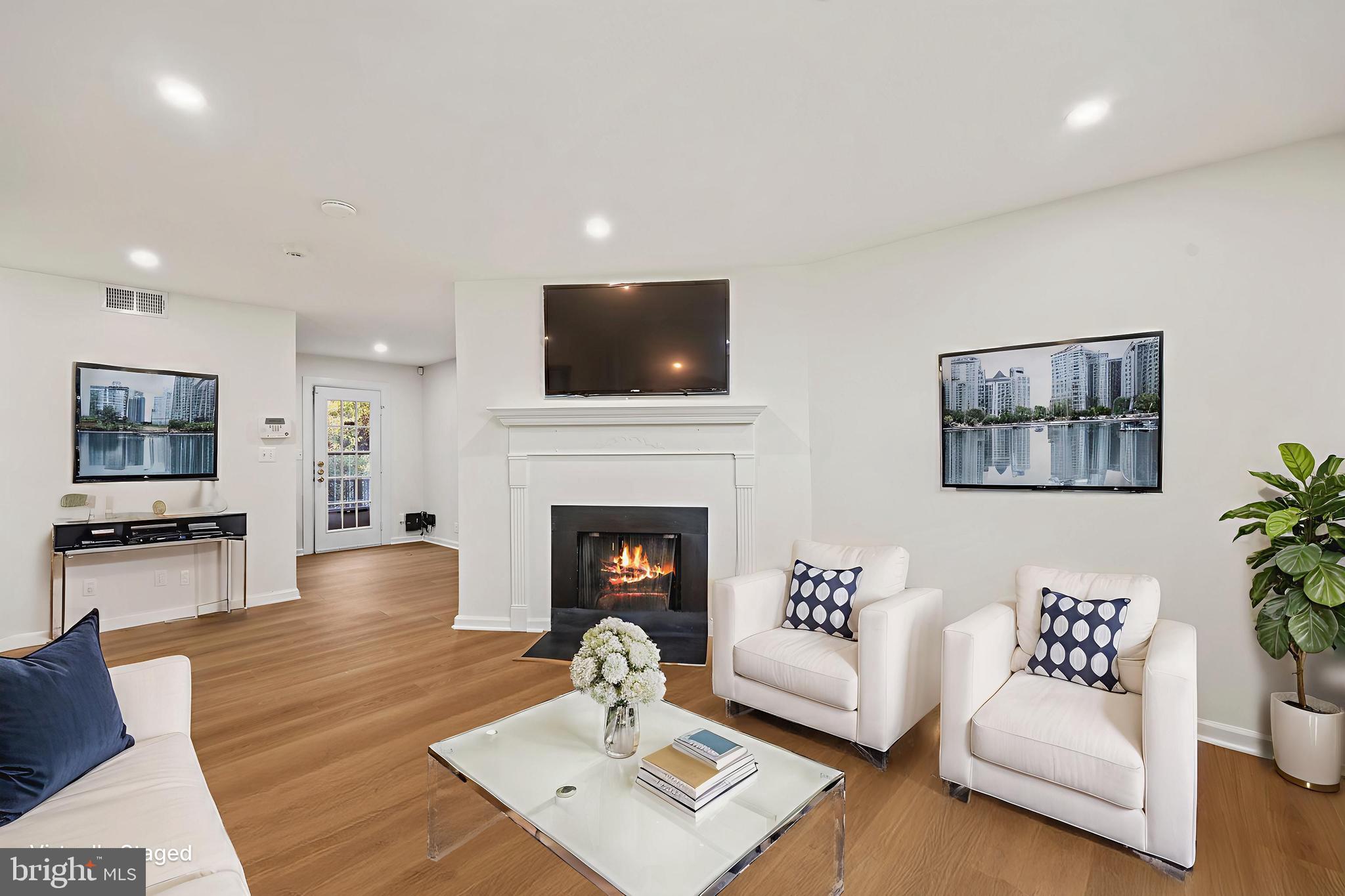 4619 28th Road South, Unit C Arlington, VA 22206 - Photo 6 of 31 a living room with furniture a flat screen tv and a fireplace