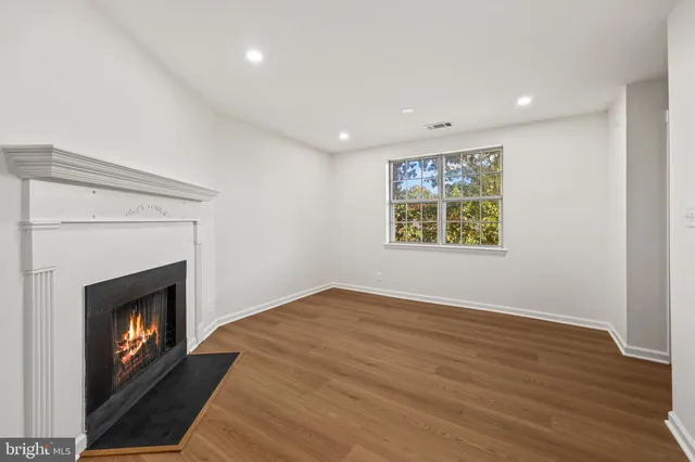 a view of an empty room and fire place