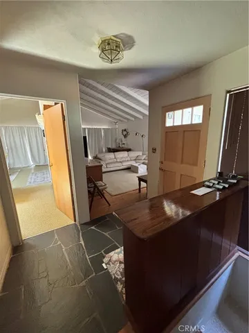 a dining room with furniture and a flat screen tv