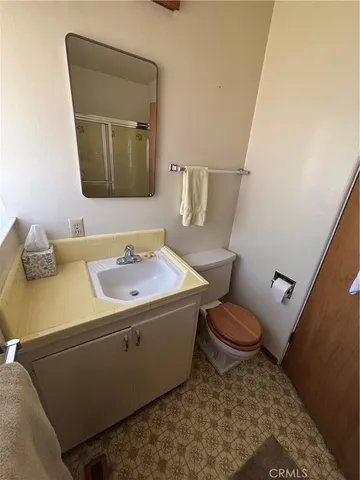 a bathroom with a sink toilet and mirror