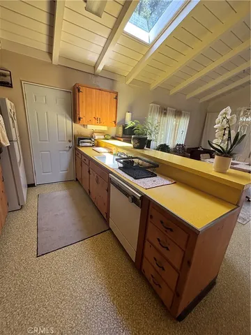 a kitchen with stainless steel appliances granite countertop a sink counter space and cabinets