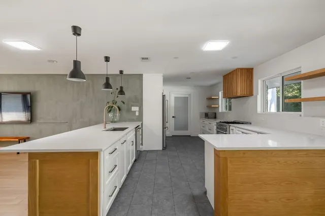 a kitchen with a sink a stove and refrigerator