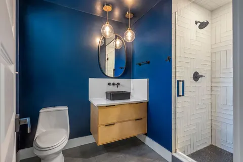 a bathroom with a toilet a sink and mirror