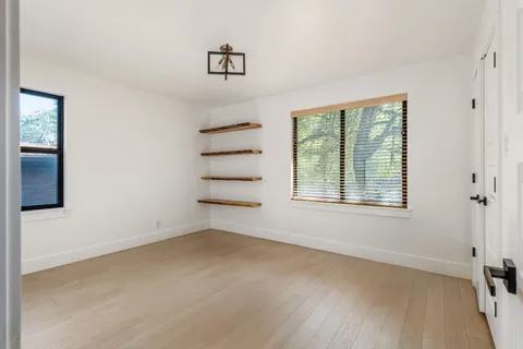 wooden floor in an empty room with a window