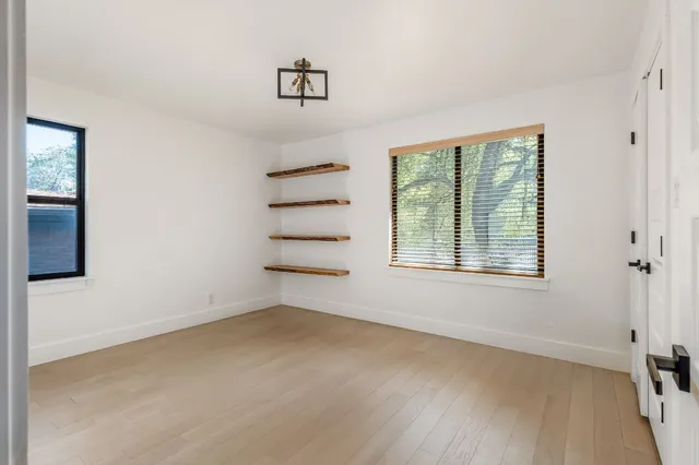 wooden floor in an empty room with a window