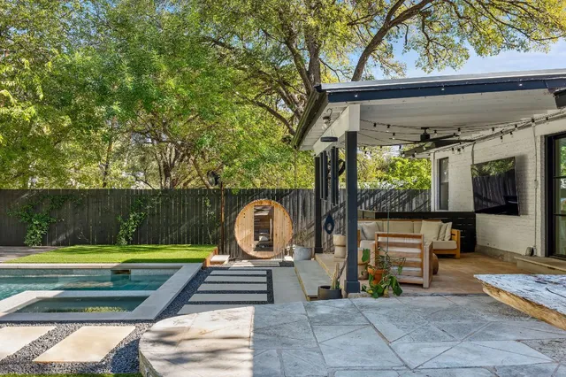 a view of swimming pool with sitting area and garden