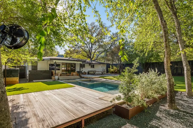 a view of a house with swimming pool and sitting area