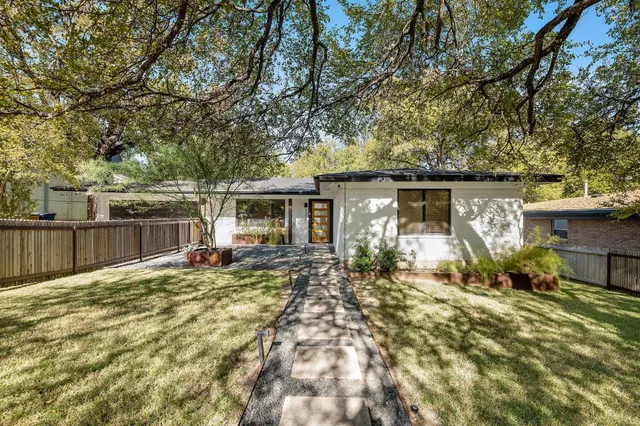 a front view of house with yard outdoor seating and barbeque oven