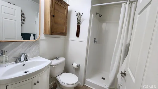 a bathroom with a toilet sink and shower