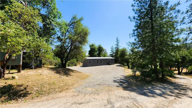 a brick house with a yard covered in snow