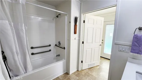 a bathroom with a bathtub and a shower