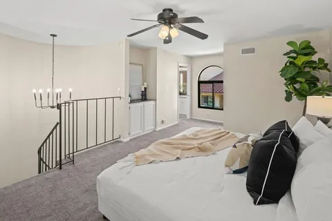 a bedroom with a bed and a chandelier