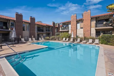 a swimming pool with outdoor seating and yard