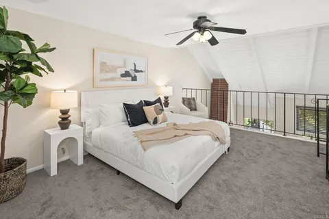a bedroom with bed and a chandelier
