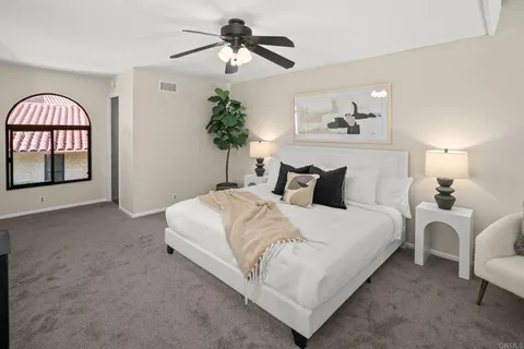 a bedroom with bed and a chandelier