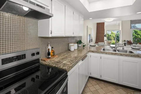 a kitchen with a sink stove and cabinets