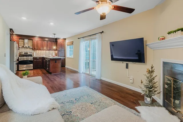 a living room with fireplace furniture and a flat screen tv