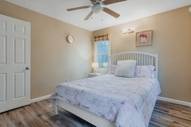 a bedroom with a large bed and a window