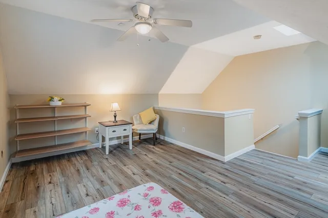 a living room with a baby crib furniture and a wooden floor
