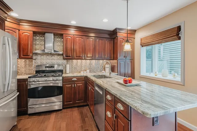 a kitchen with stainless steel appliances granite countertop a stove and a sink