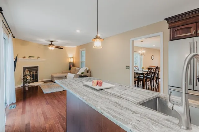 a very nice looking dining room with a table chairs and a kitchen view