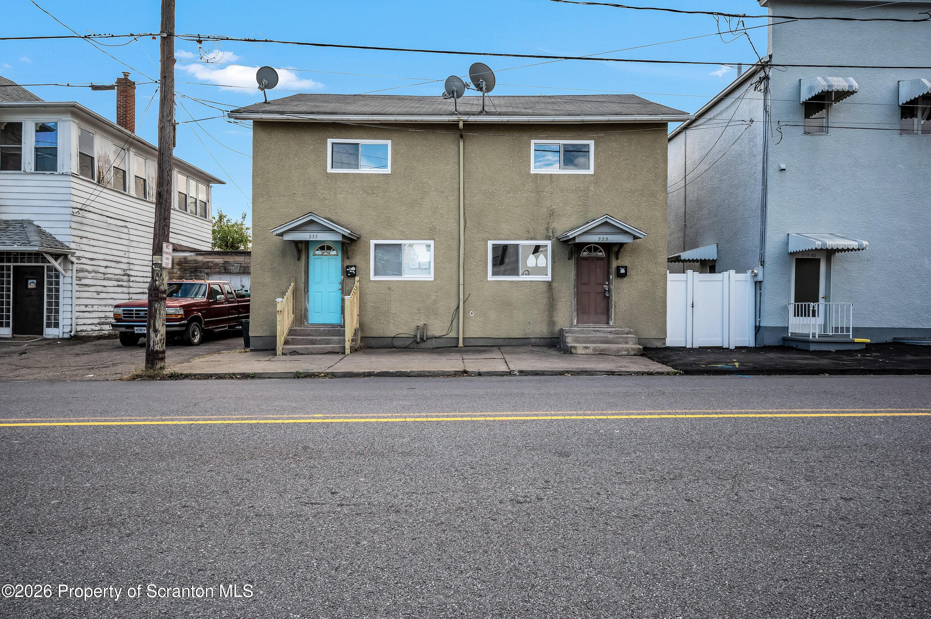 a front view of a house with a road
