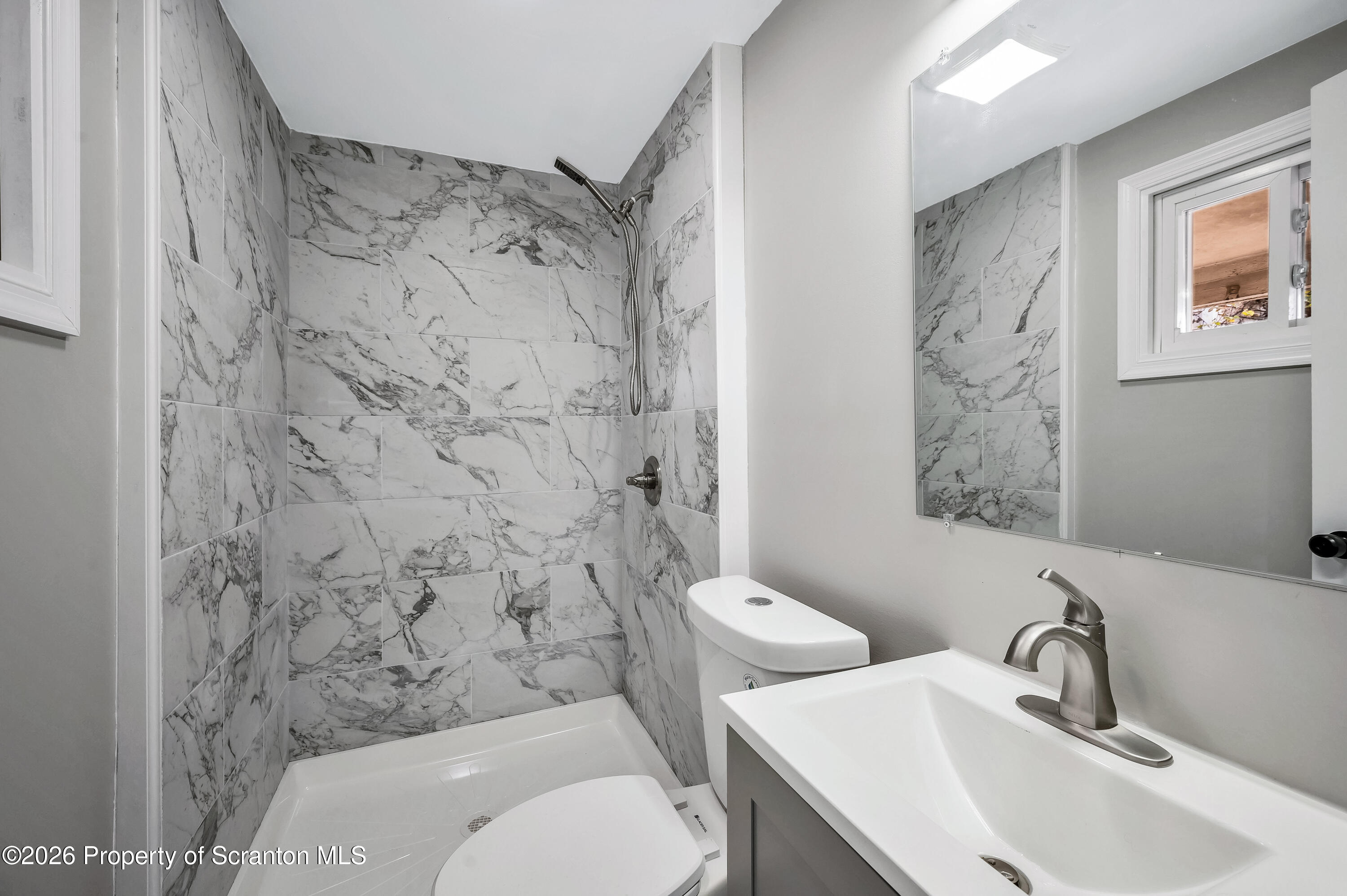 333 Oak Street, Unit 1/2 Scranton, PA 18508 - Photo 6 of 11 a bathroom with a toilet sink and mirror