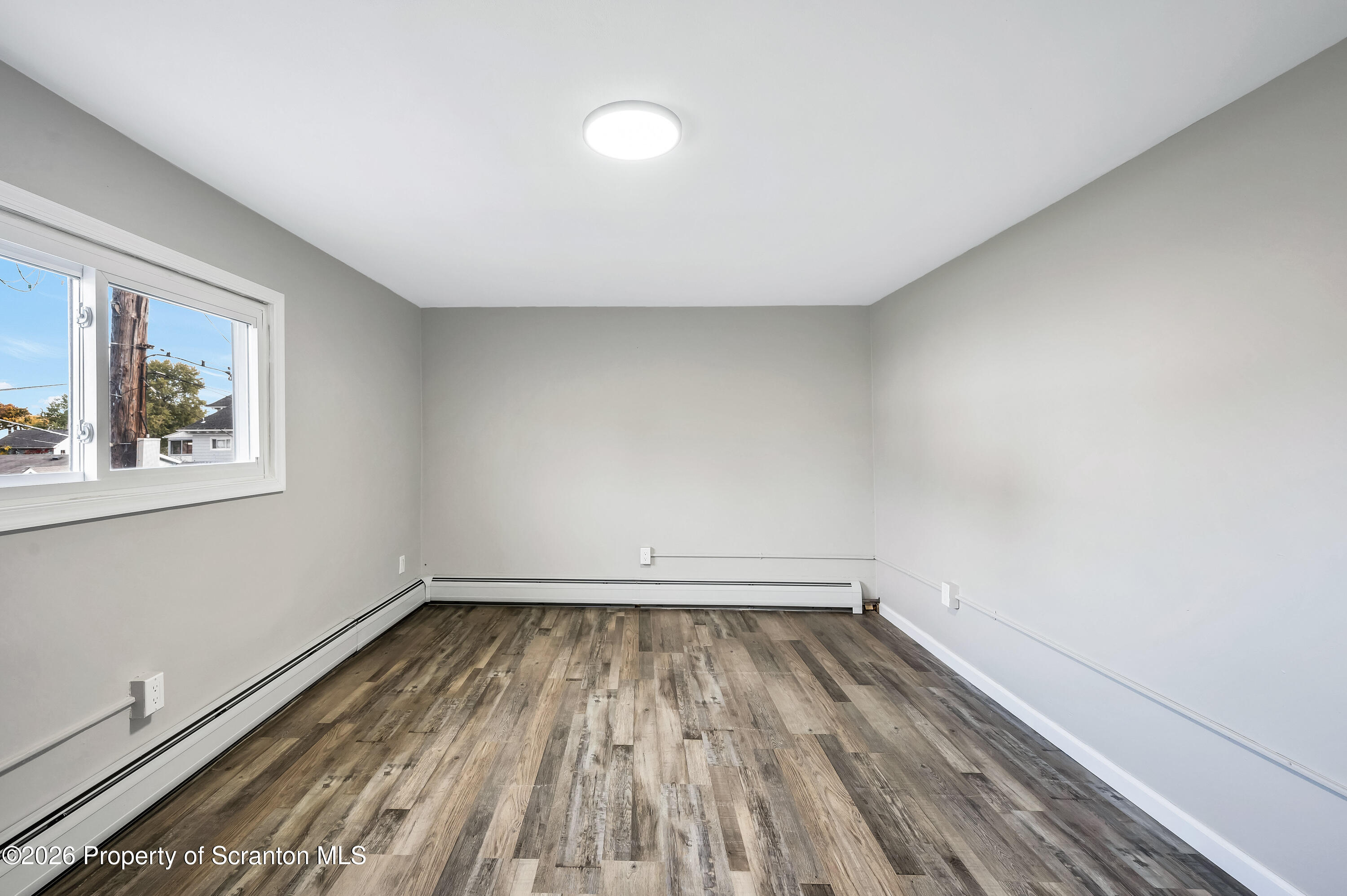 333 Oak Street, Unit 1/2 Scranton, PA 18508 - Photo 8 of 11 a view of room with window and hardwood floor