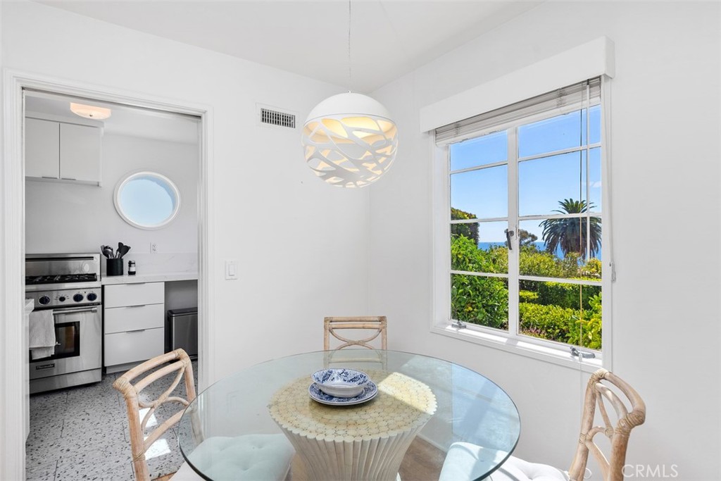 2142 Ruby Place Laguna Beach, CA 92651 - Photo 13 of 34 a view of a dining room with furniture a chandelier and wooden floor