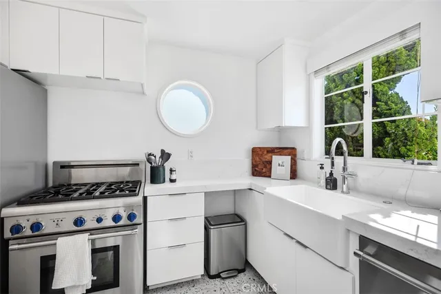 a kitchen with a stove and a sink