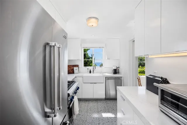 a kitchen with a sink stainless steel appliances and cabinets