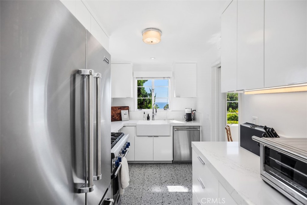 2142 Ruby Place Laguna Beach, CA 92651 - Photo 18 of 34 a kitchen with a sink stainless steel appliances and cabinets