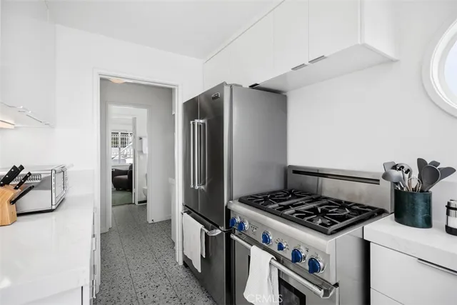 a kitchen with a stove and a refrigerator
