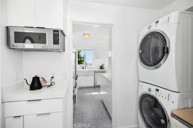 a view of a kitchen with sink washer and dryer