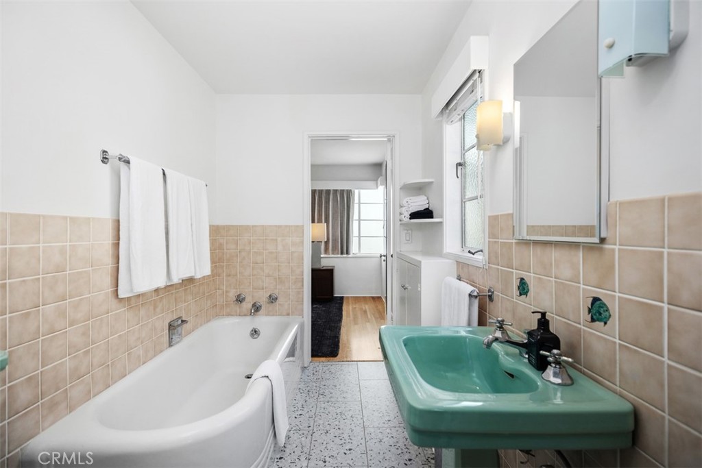 2142 Ruby Place Laguna Beach, CA 92651 - Photo 23 of 34 a bathroom with a tub sink and mirror