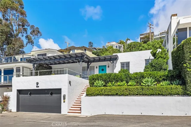 an aerial view of a house with a yard and potted plants