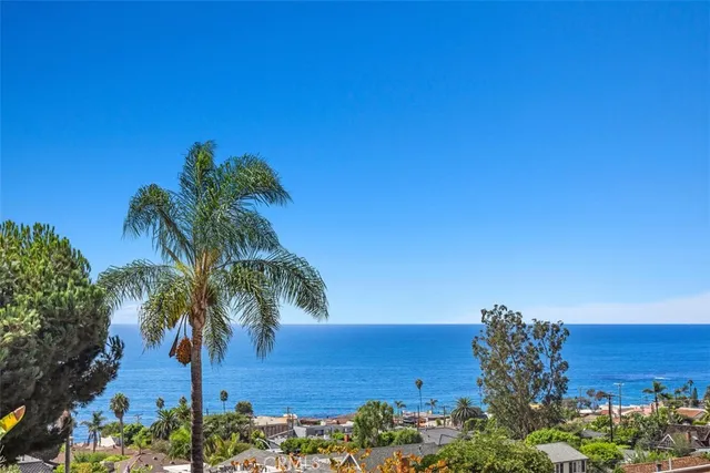a view of ocean with a building in the background