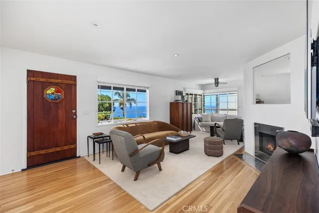 a living room with furniture rug and wooden floor