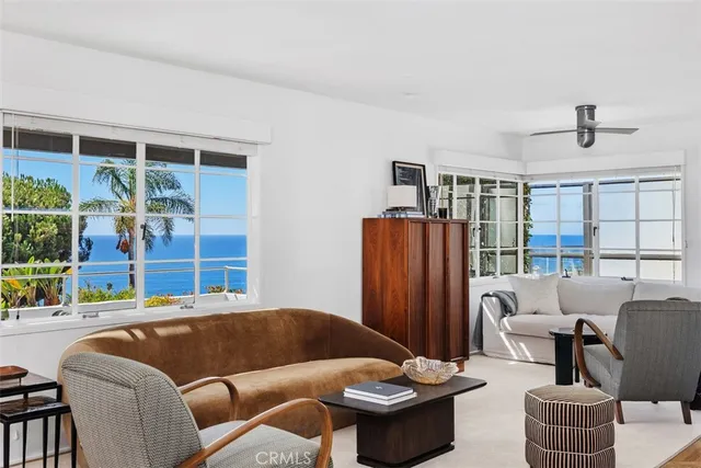 a living room with furniture ceiling fan and a window