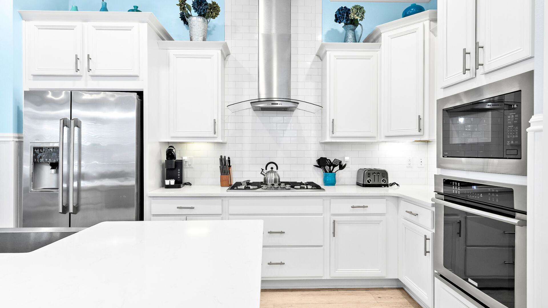 53 East E Pine, Unit A Inlet Beach, FL 32461 - Photo 12 of 59 a kitchen with granite countertop white cabinets and stainless steel appliances