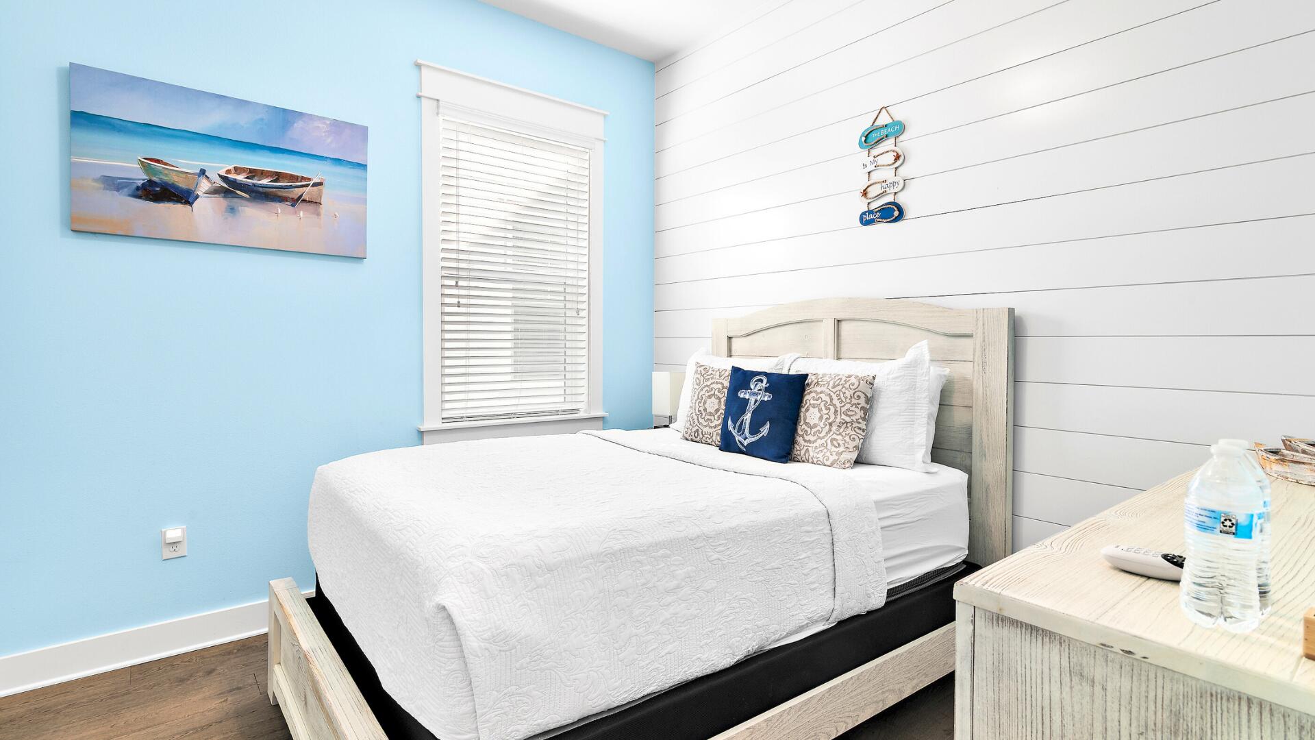 53 East E Pine, Unit A Inlet Beach, FL 32461 - Photo 28 of 59 a bedroom with a bed and wooden floor