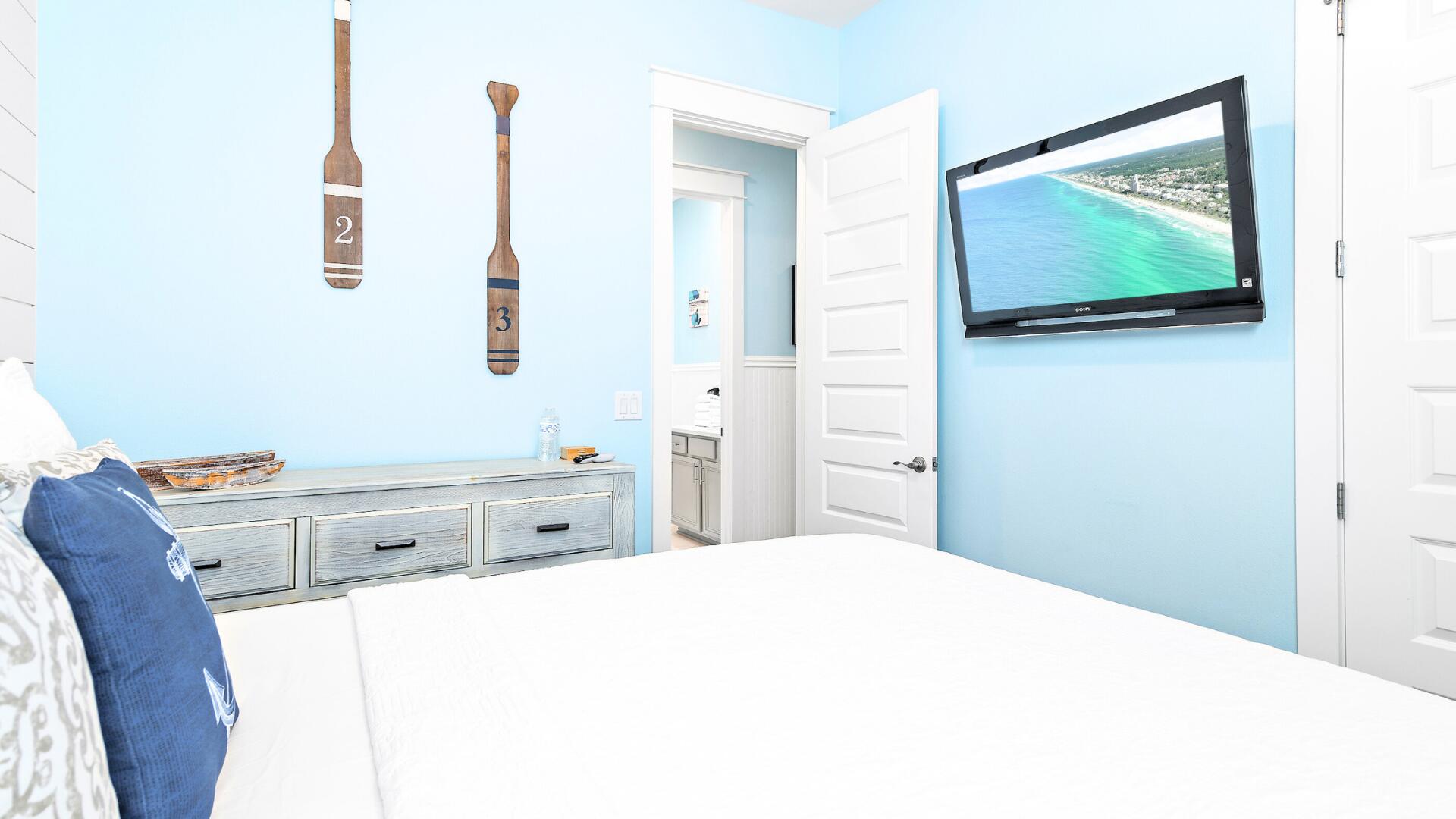 53 East E Pine, Unit A Inlet Beach, FL 32461 - Photo 29 of 59 a bedroom with a bed and a flat screen tv