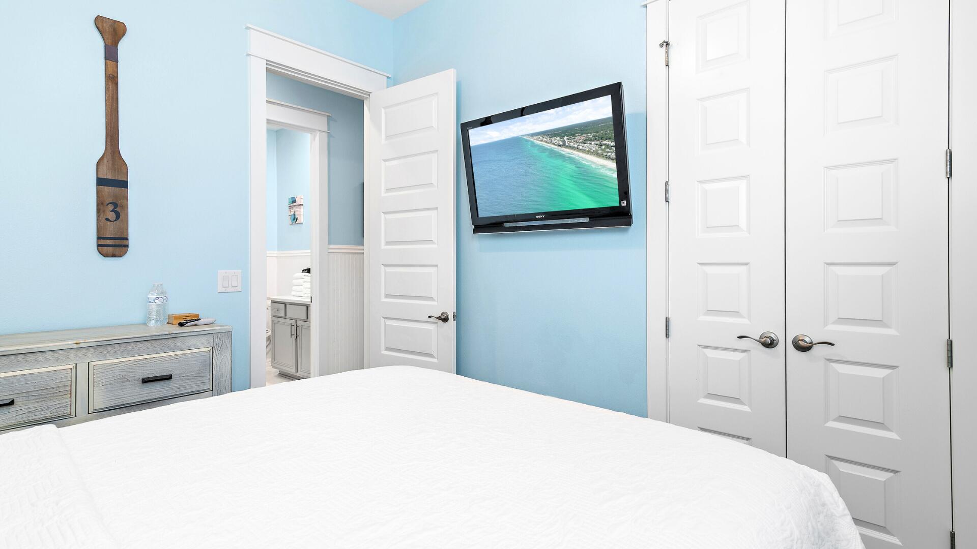 53 East E Pine, Unit A Inlet Beach, FL 32461 - Photo 31 of 59 a bedroom with a bed and a flat tv screen on the dresser