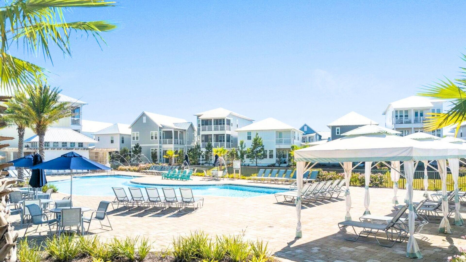 53 East E Pine, Unit A Inlet Beach, FL 32461 - Photo 41 of 59 a view of a swimming pool with a lawn chairs under an umbrella