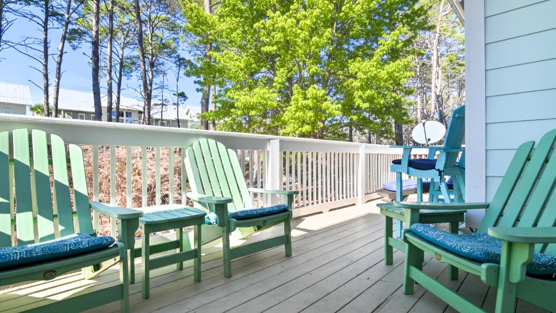 53 East E Pine, Unit A Inlet Beach, FL 32461 - Photo 10 of 59 a view of a chairs and table in patio with wooden fence