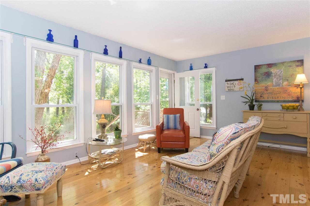 4708 Rampart Street Raleigh, NC 27609 - Photo 1 of 25 a living room with furniture and a floor to ceiling window